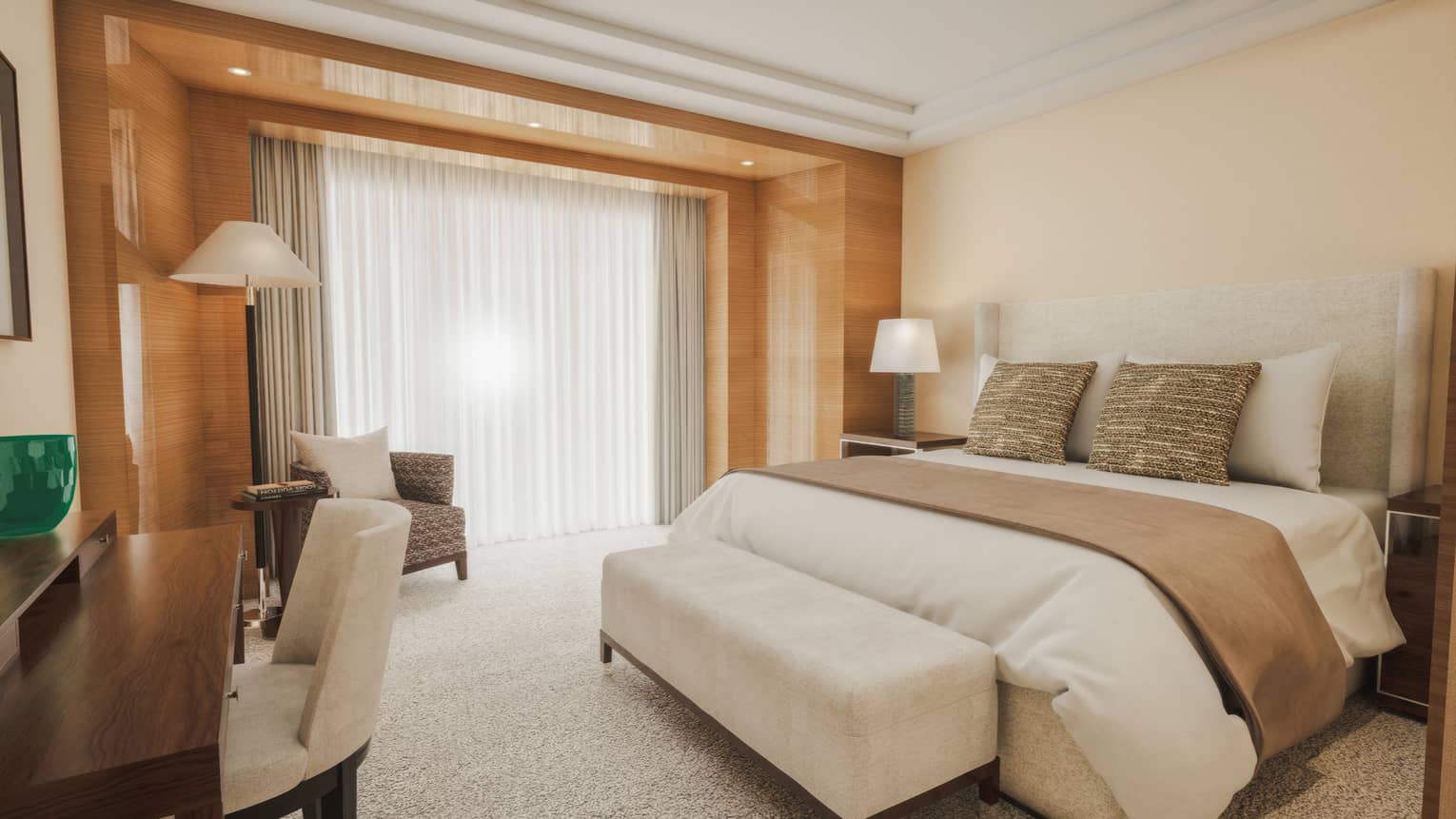 Hotel suite bedroom featuring a king bed with ivory coloured carpeting and sycamore panelled walls