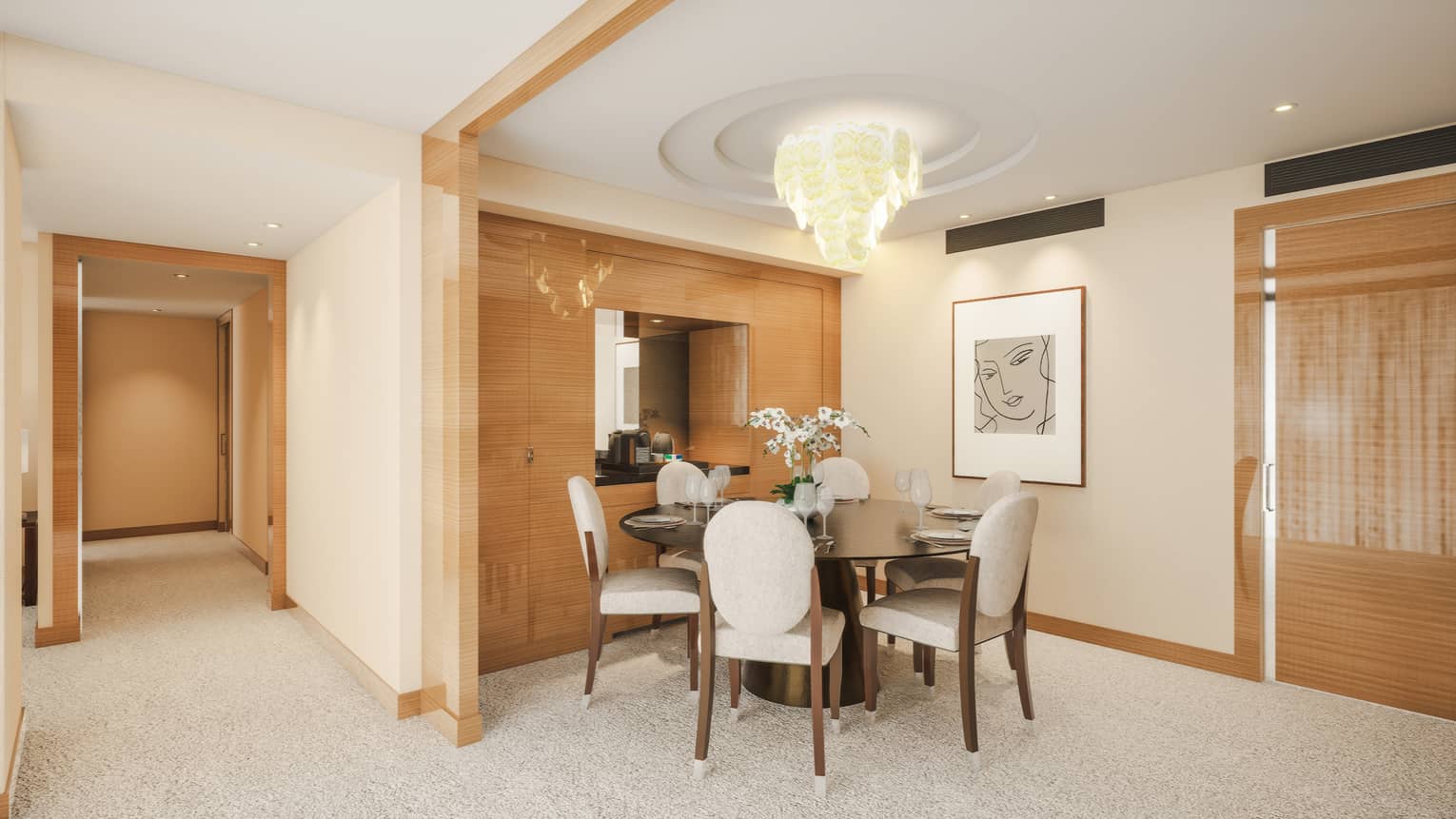 Luxury hotel suite's dining room featuring a round table and four upholstered chairs under a chandelier