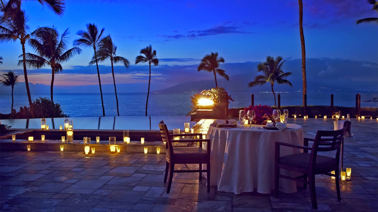 An outdoor candlelit dinner by the seaside in Maui