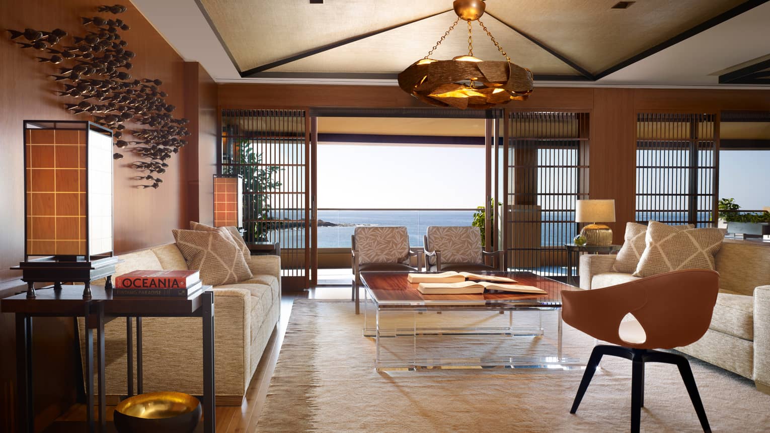 Alii Royal Suite spacious seating area with bespoke furnishings, mid-century style sofas, chairs, light