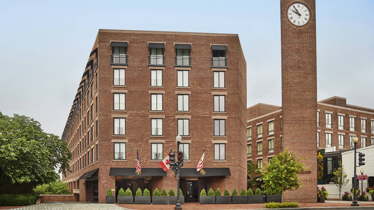 Four Seasons Hotel Washington brown brick building exterior with clock tower