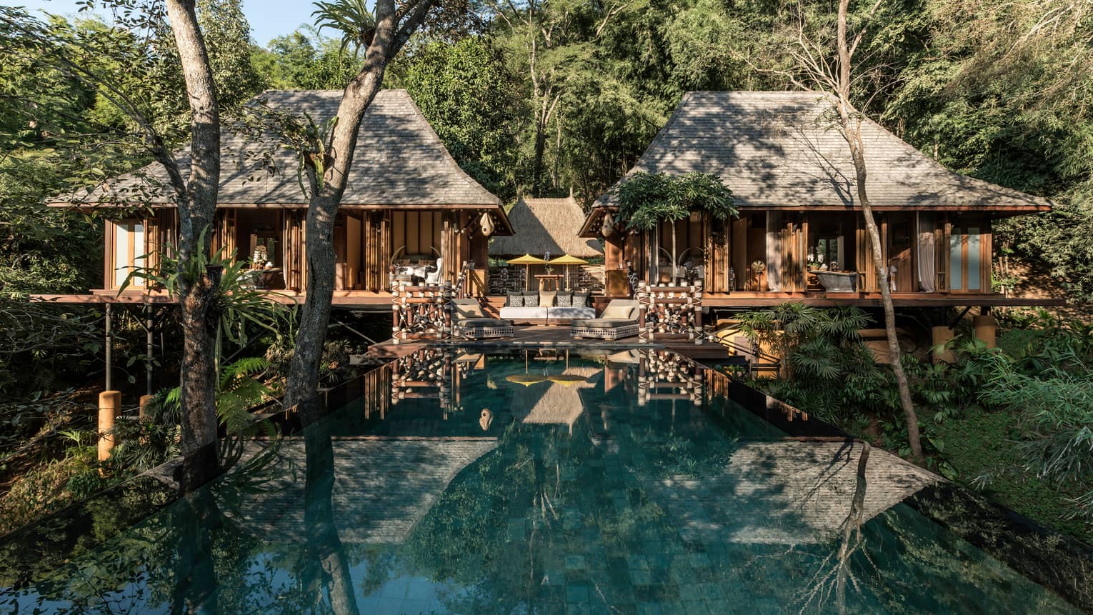 Explorer's Lodge bungalows with small patio in middle leading to long swimming pool
