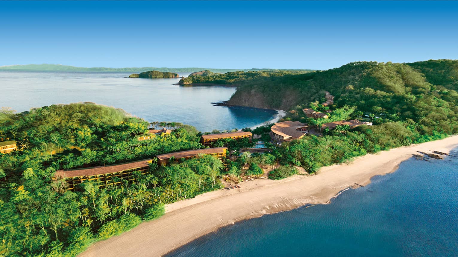 Looking down at Four Seasons Hotel Costa Rica at Peninsula Papagayo on tropical sandbar behind beach, ocean on either side