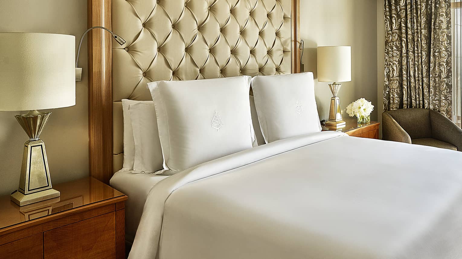 Four Seasons Suite, showing white-dressed bed and city views from windows