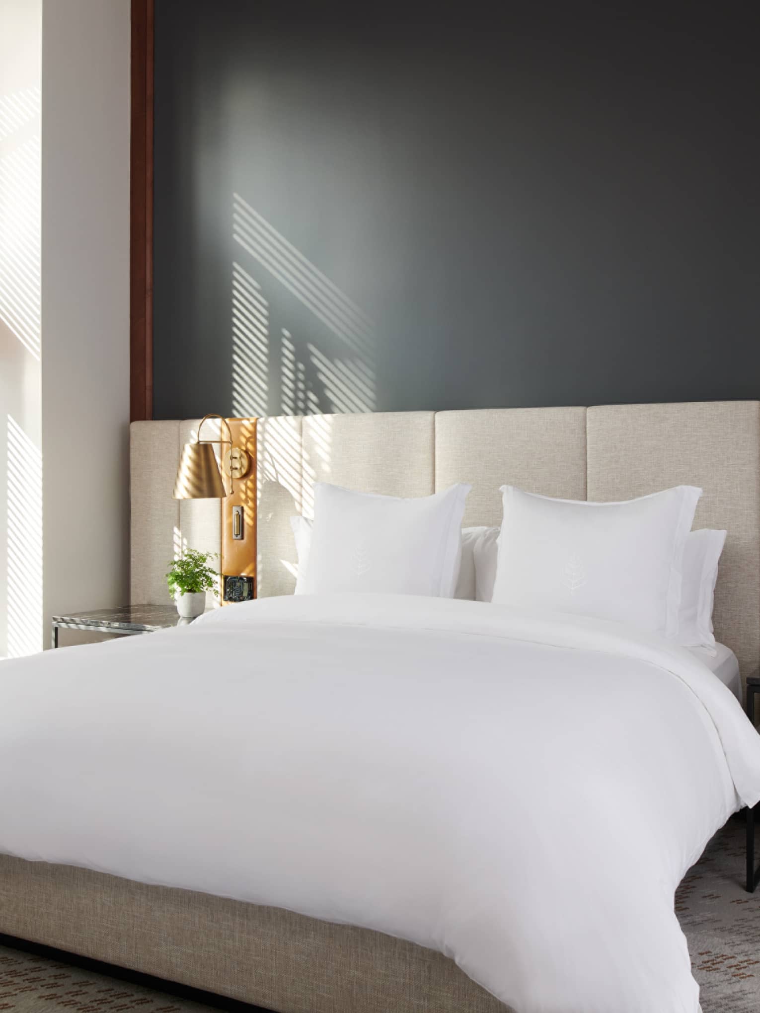 Elegant bedroom in the Executive Suite at Four Seasons Whistler, featuring a large bed with pristine white bedding. The room includes a stylish bedframe and headboard, bedside tables with modern lamps, and a bench at the foot of the bed. Large windows with wooden blinds allow for ample natural light, creating a warm and inviting atmosphere. The decor is complemented by soft neutral tones and contemporary design elements.,Elegant bedroom in the Executive Suite at Four Seasons Whistler, featuring a large bed with pristine white bedding. The room includes a stylish bedframe and headboard, bedside tables with modern lamps, and a bench at the foot of the bed. Large windows with wooden blinds allow for ample natural light, creating a warm and inviting atmosphere. The decor is complemented by soft neutral tones and contemporary design elements.