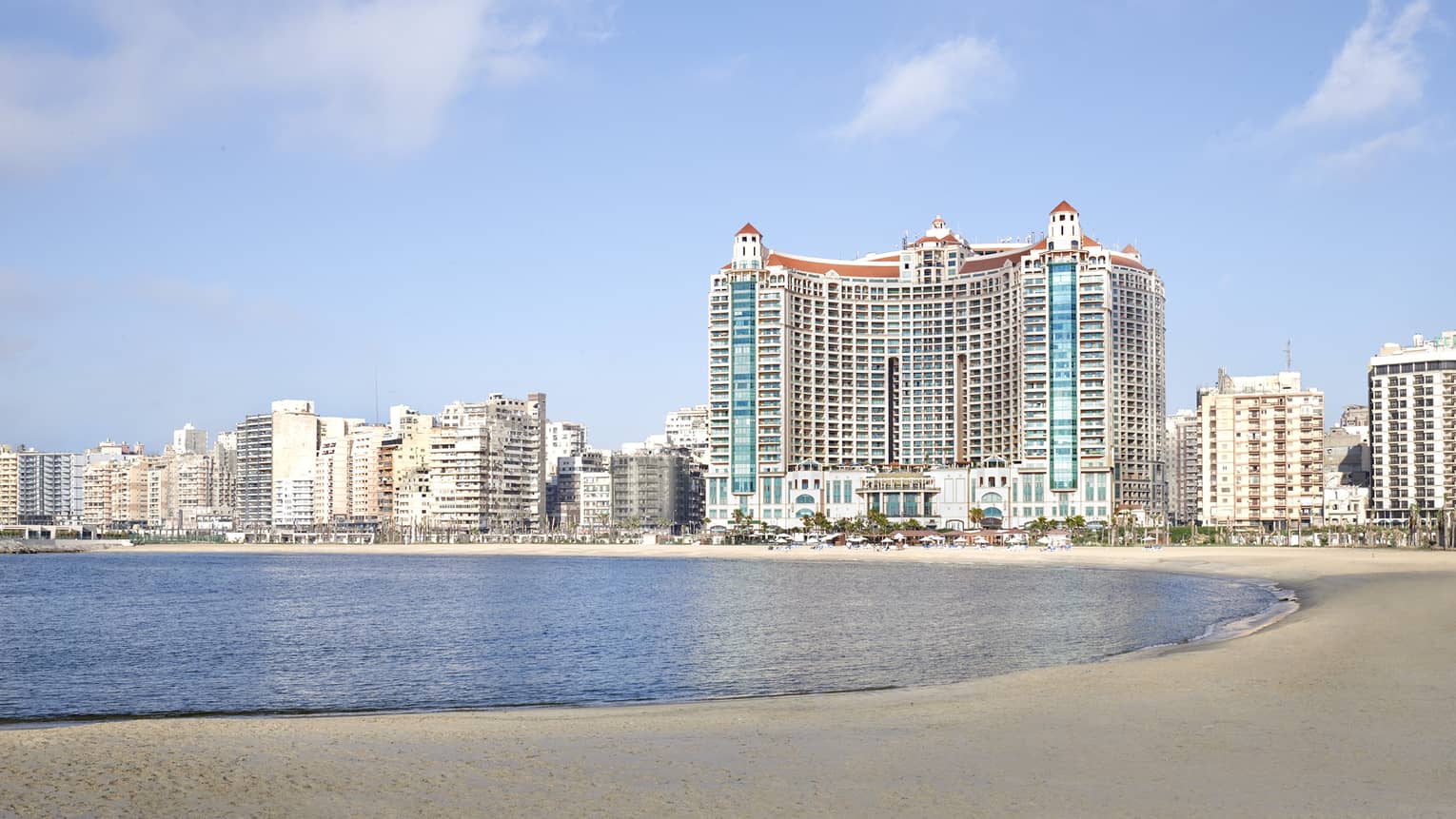 Hotel exterior against backdrop of the city on the beach