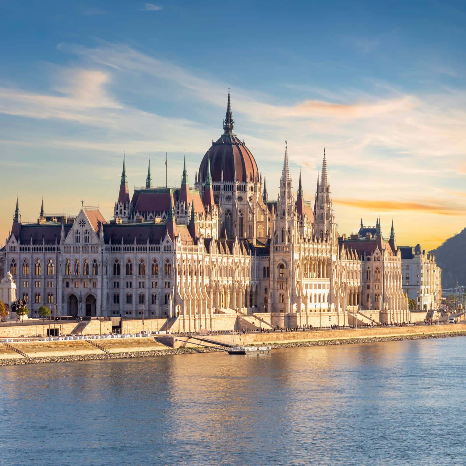 A large castle or palace on the edge of water.