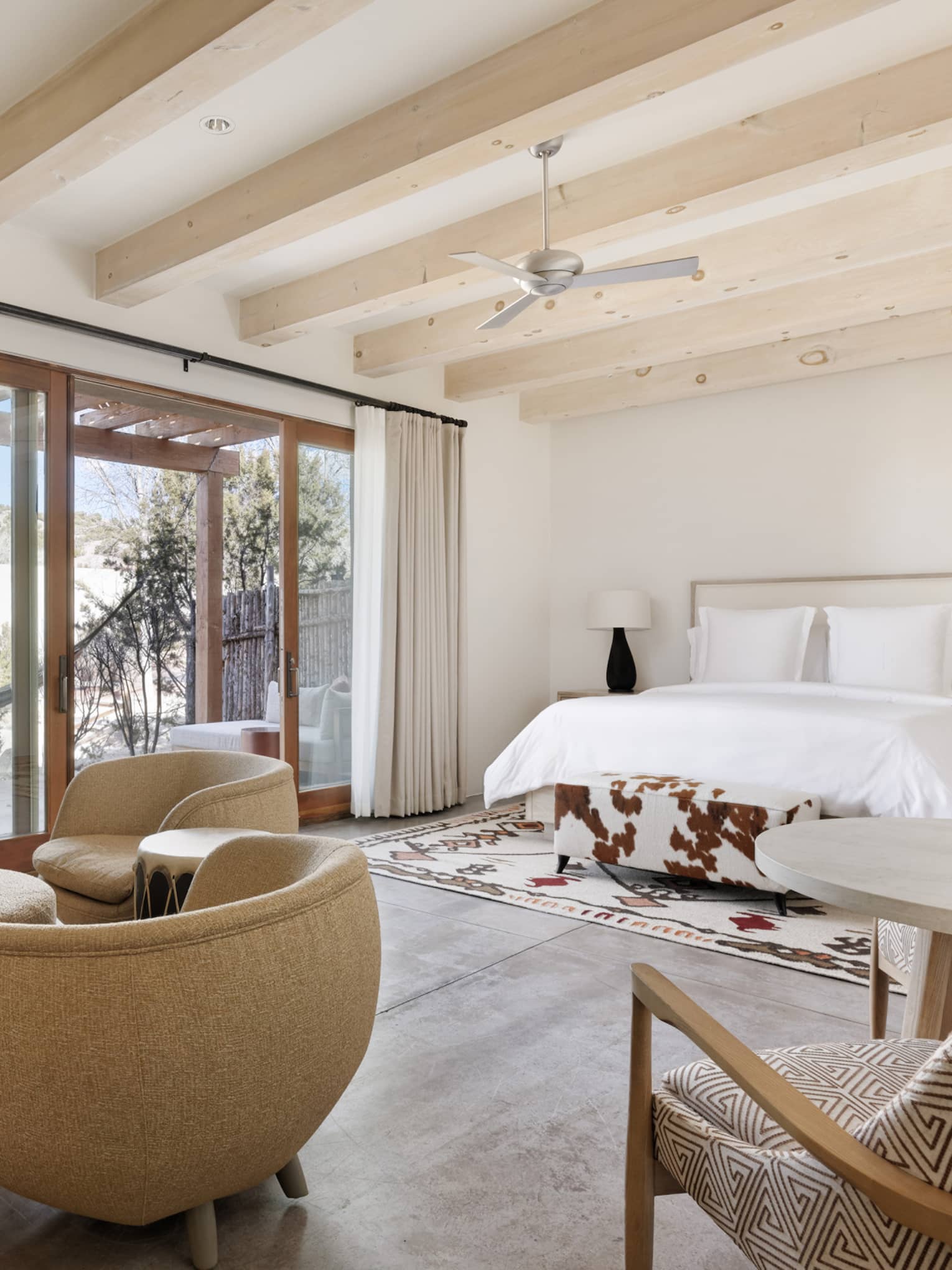 Premier guest room with sitting area, king bed and private terrace at Four Seasons Resort Santa Fe
