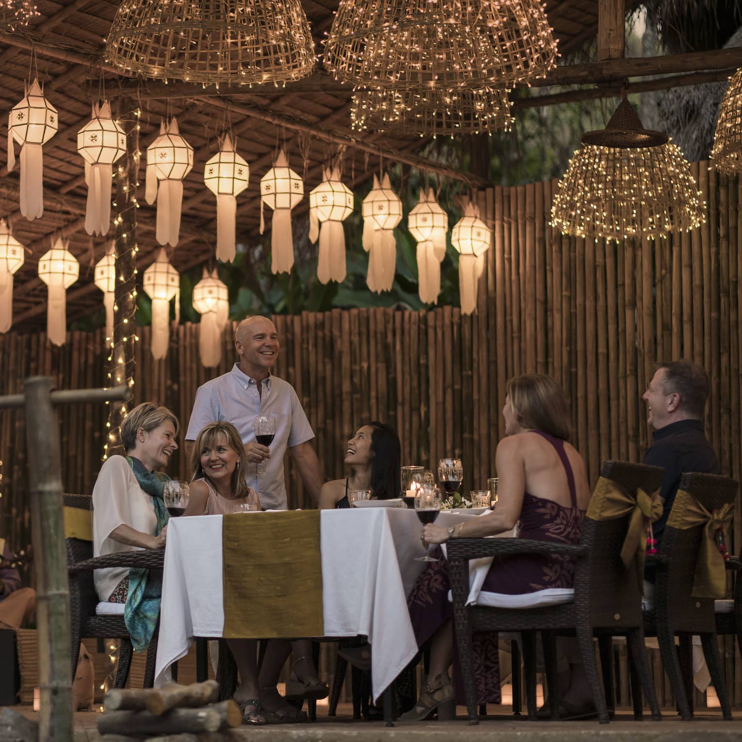 Elephant Camp Dinner, smiling group of diners unders rows of paper lanterns