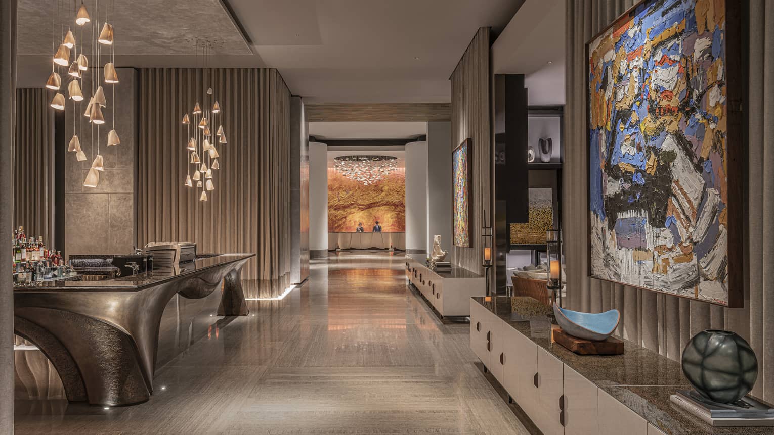 Hotel lobby, beige marble floors, abstract hanging lights, wall art
