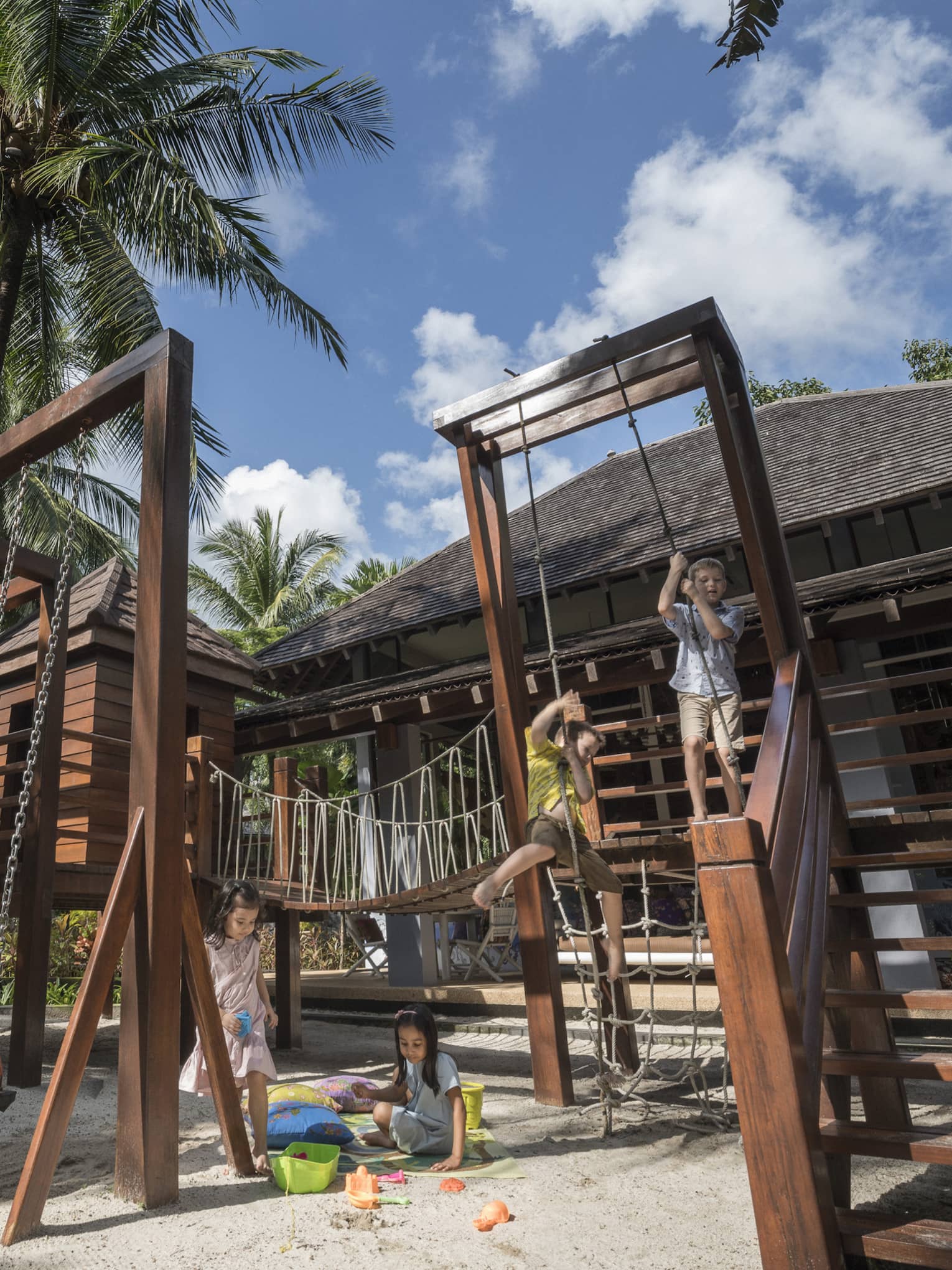 Kids playing on the play set in the kids club at Four Seasons Langkawi