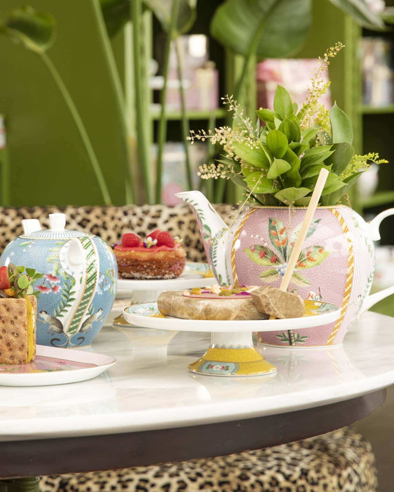 Round table with colourful tea cups and sweets at YASEMIN