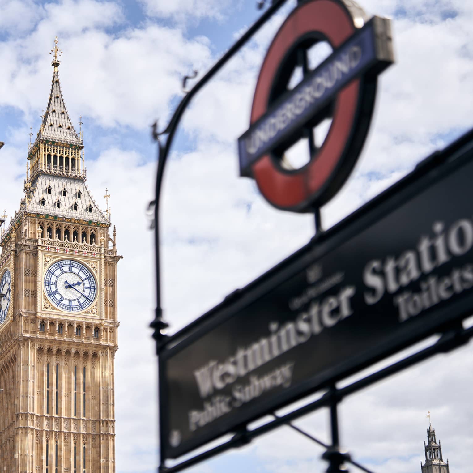 London Underground sign for Westminster Station in the foreground, Big Ben clock tower in the background.