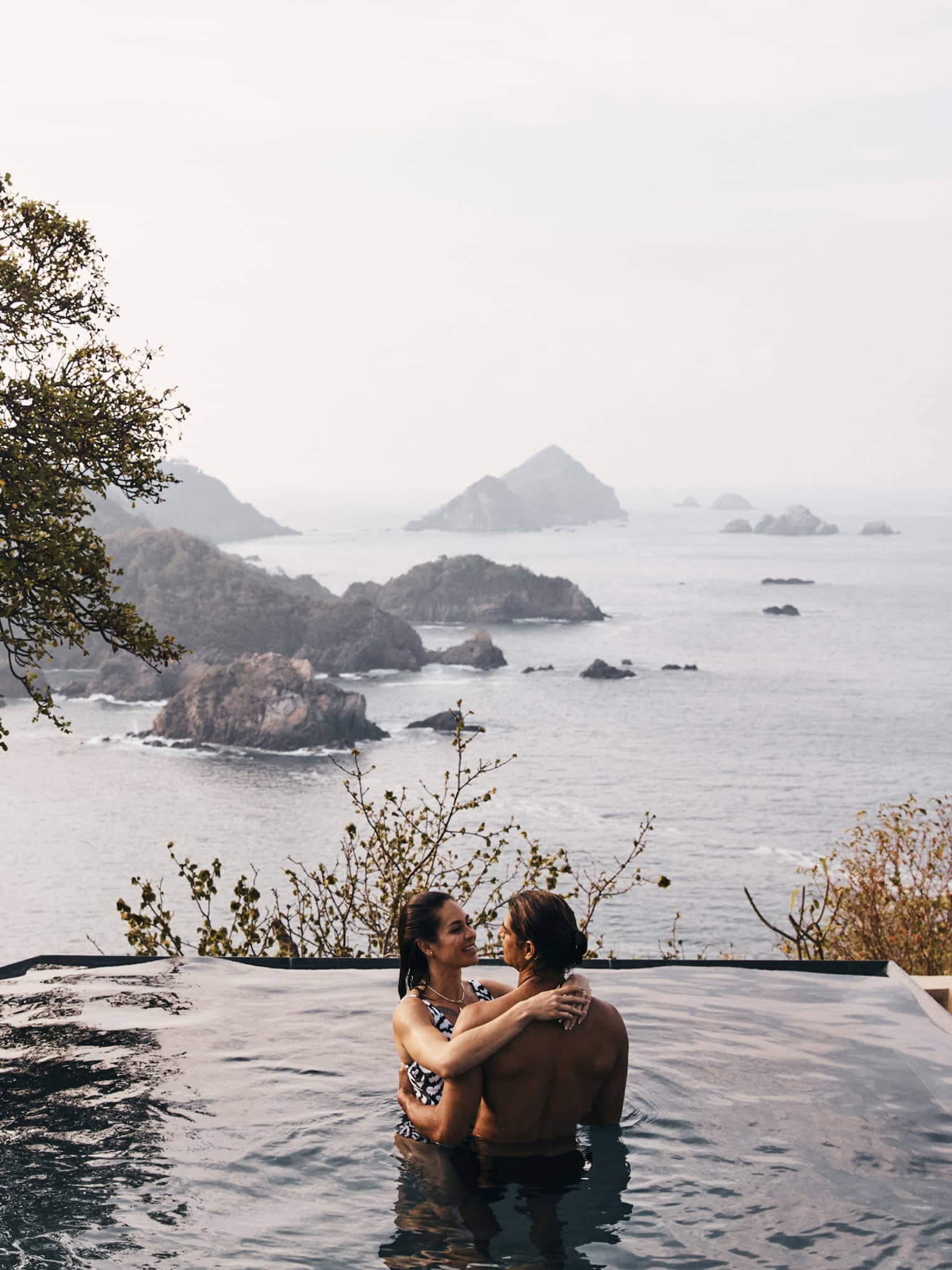 Man and woman in the outdoor infinity pool
