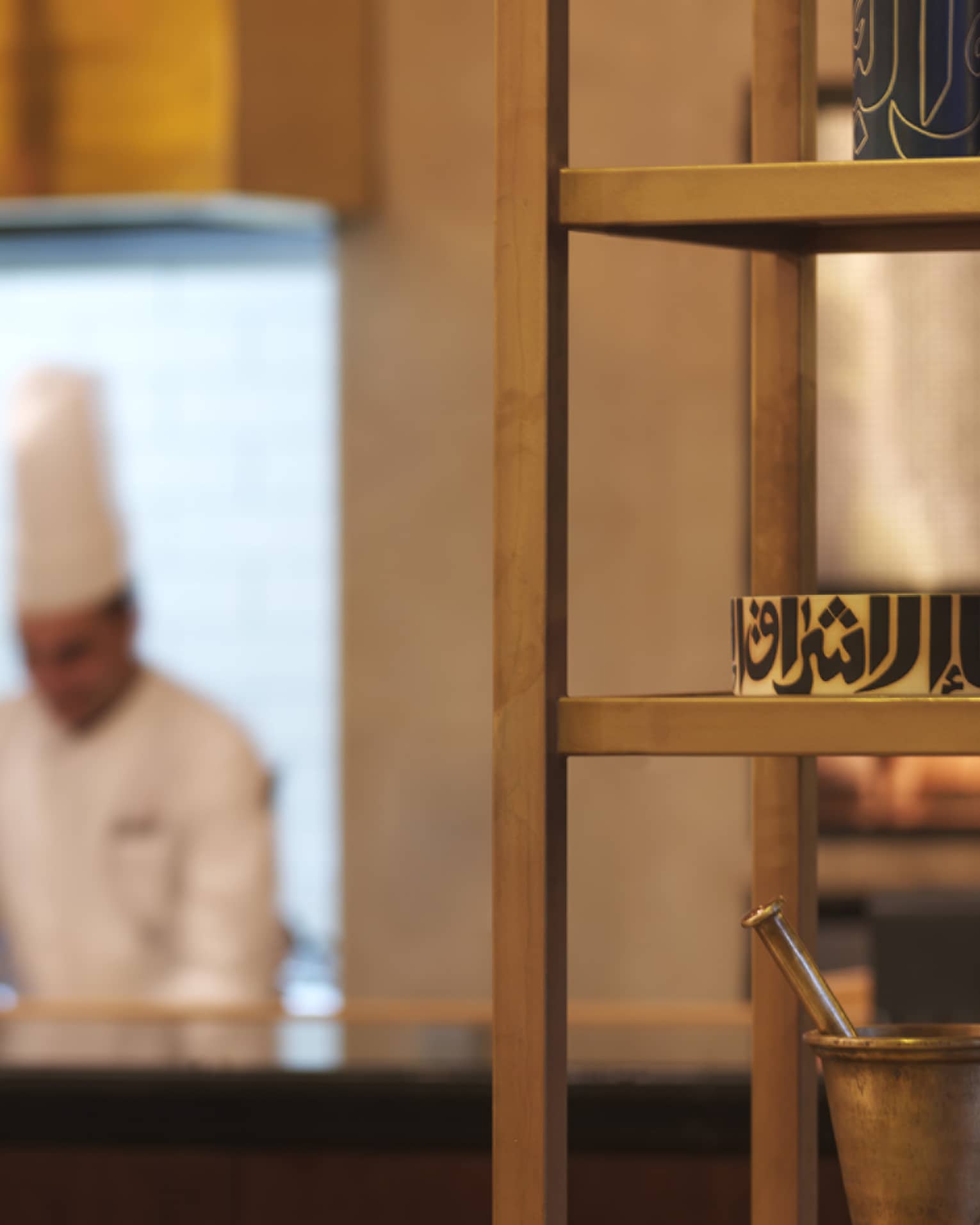 An out-of-focus shot of several chefs working in the Olea kitchen.