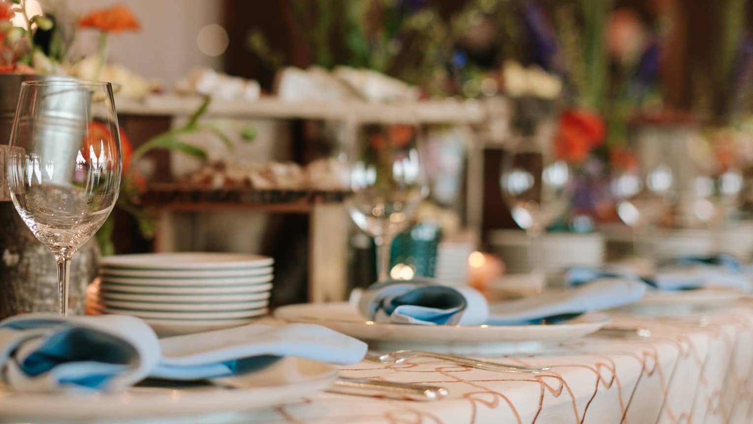 Wedding dining table set with flowers, cheeses on rustic wood platters