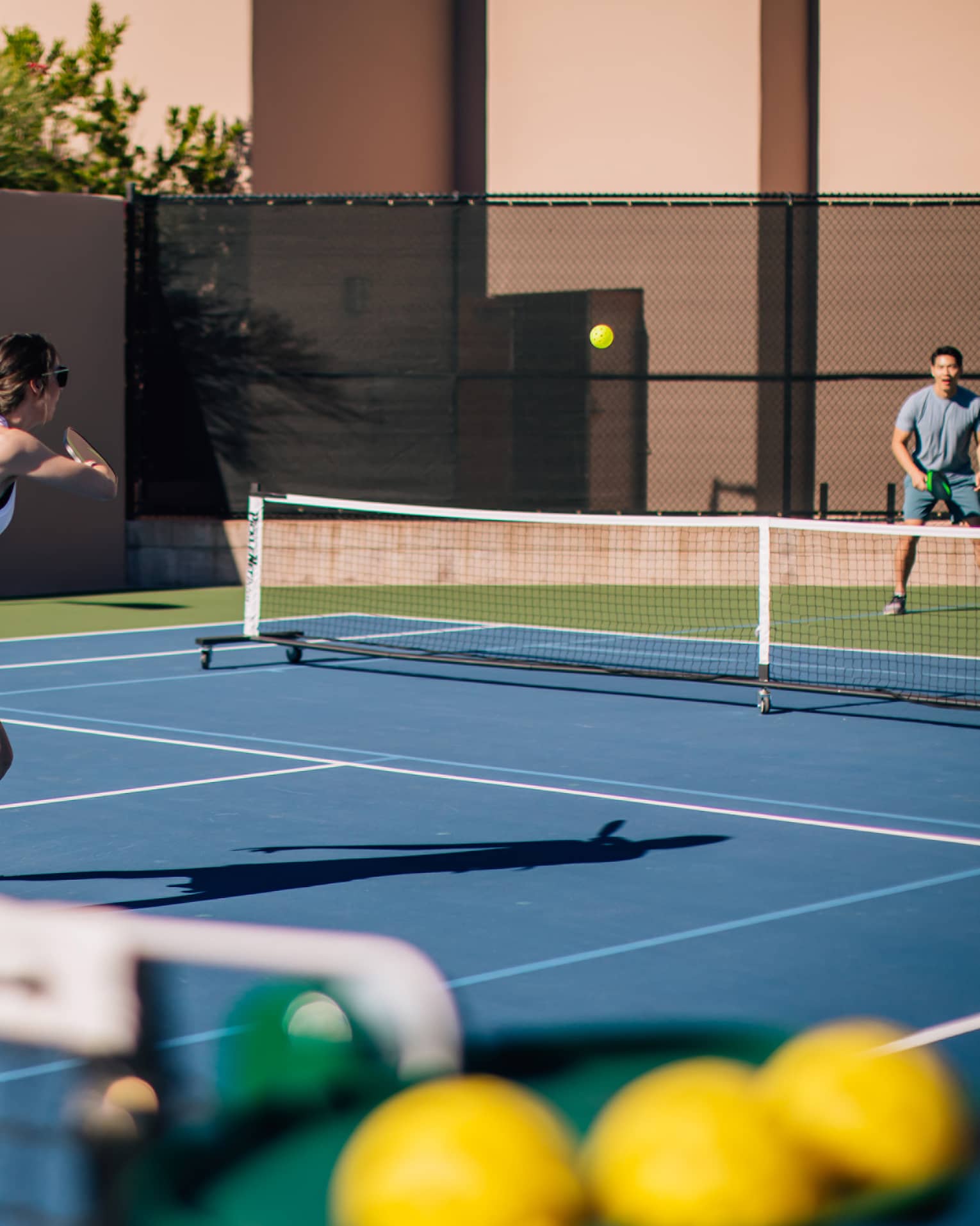 A woman and man on a tennis court.