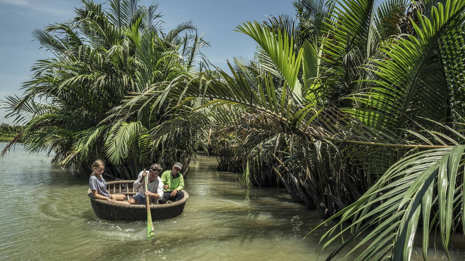 Guests paddle around Hoi An in a basket boat tour