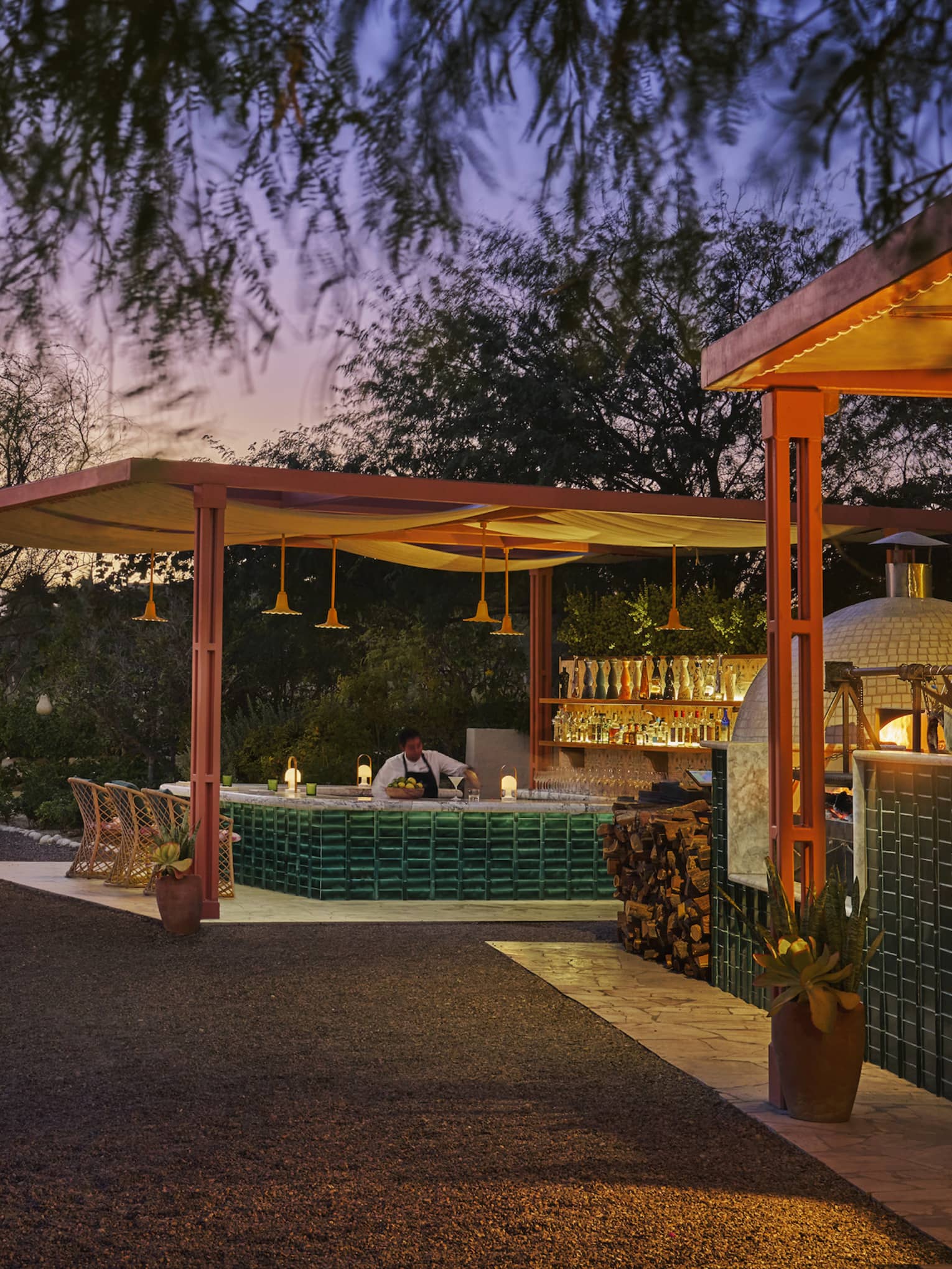 Outdoor dining with umbrellas at sunset.