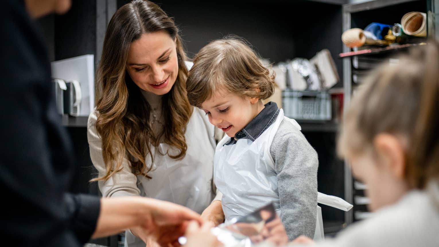 A family doing an activity in a kitchen.