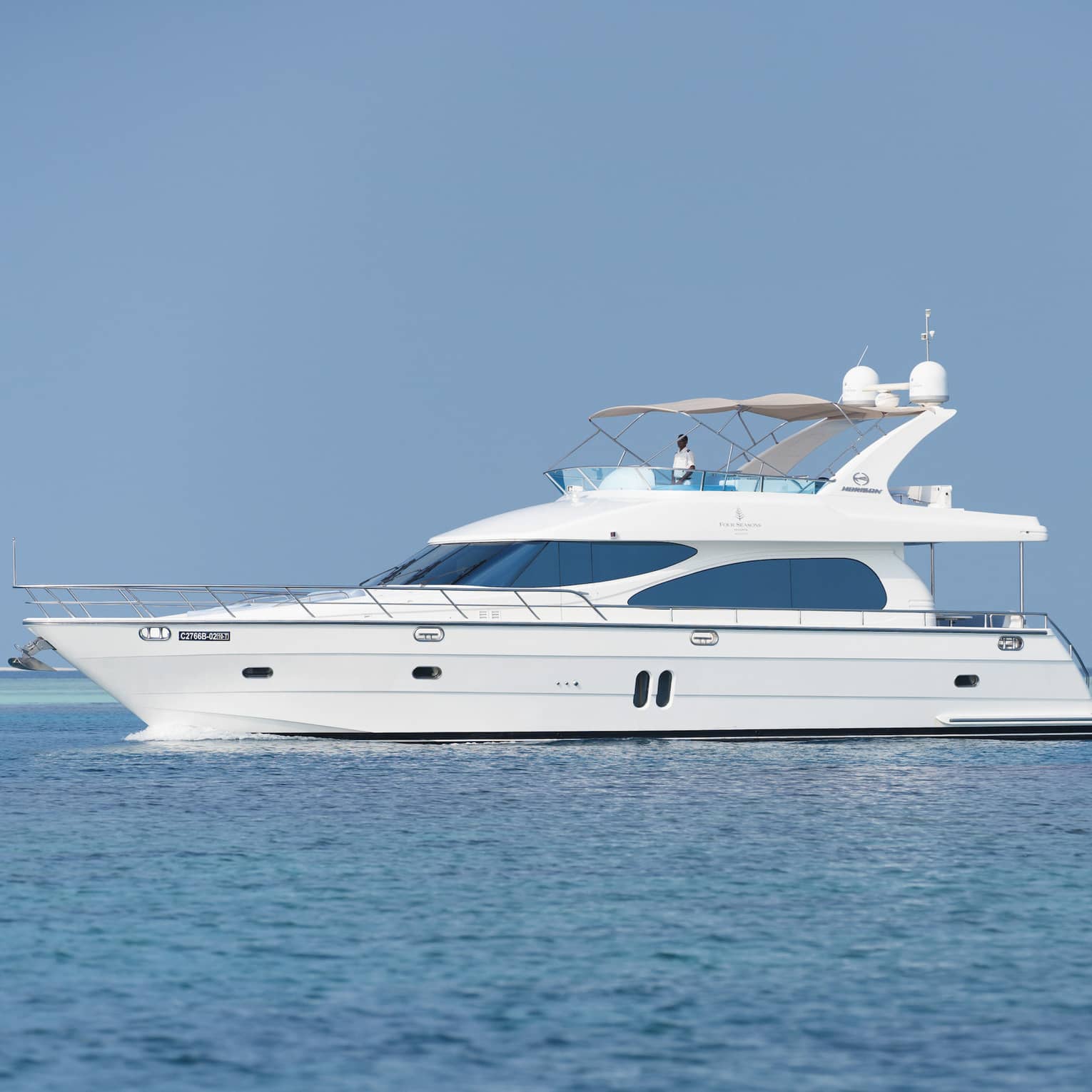 Small white private luxury yacht sailing on ocean
