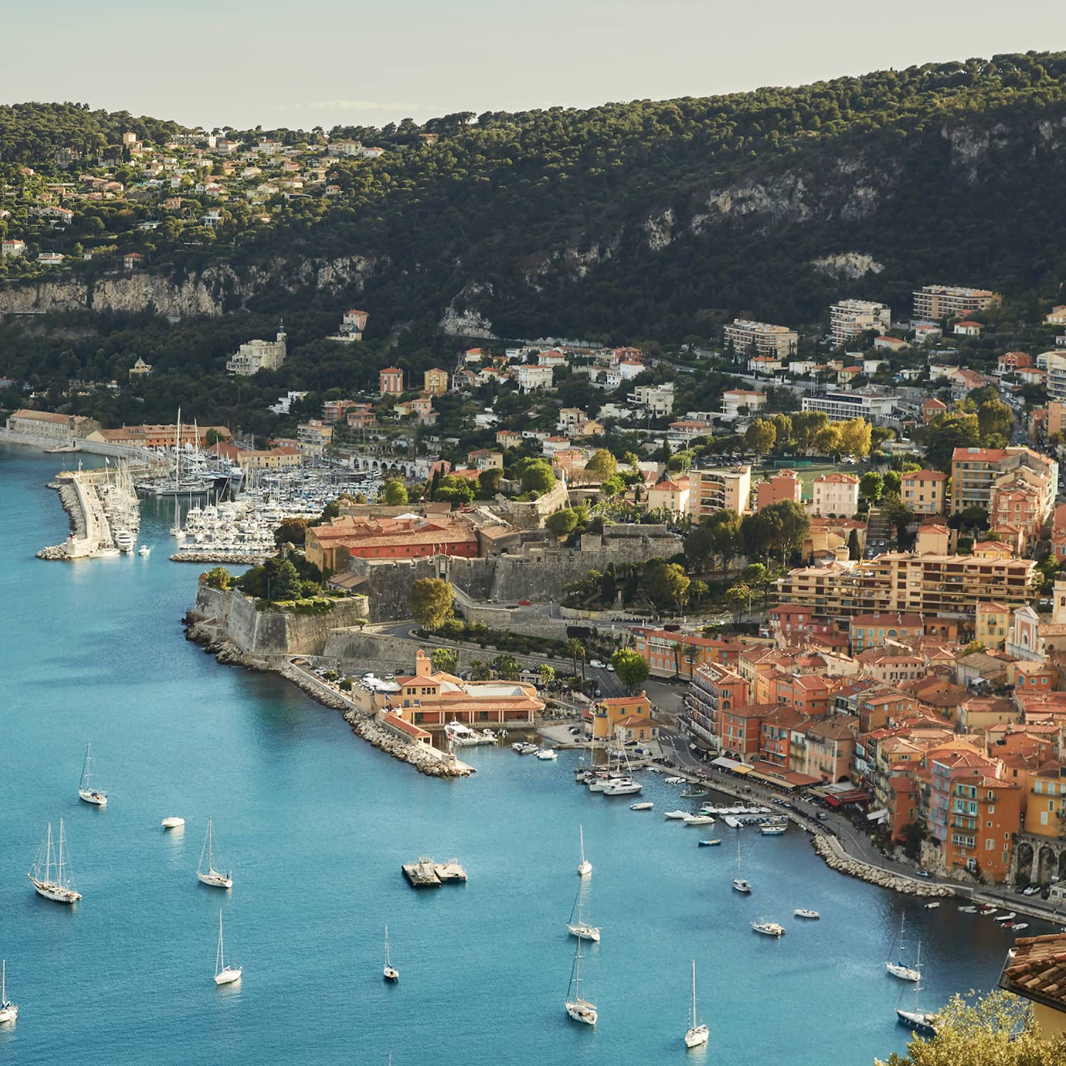 Aerial view of French Riviera waterfront, buildings along coast, yachts, boats in sea