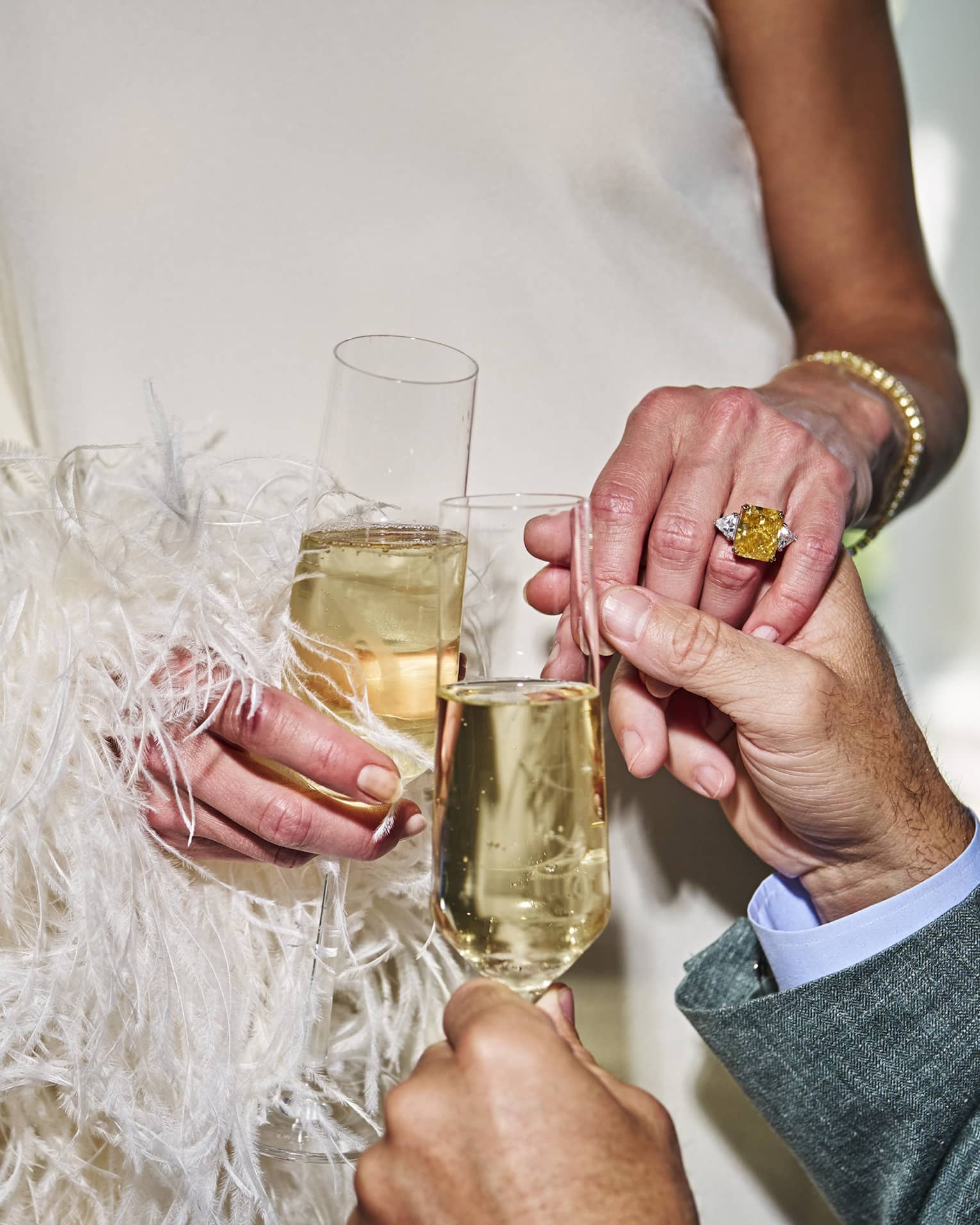 Two people holding glasses of champagne.