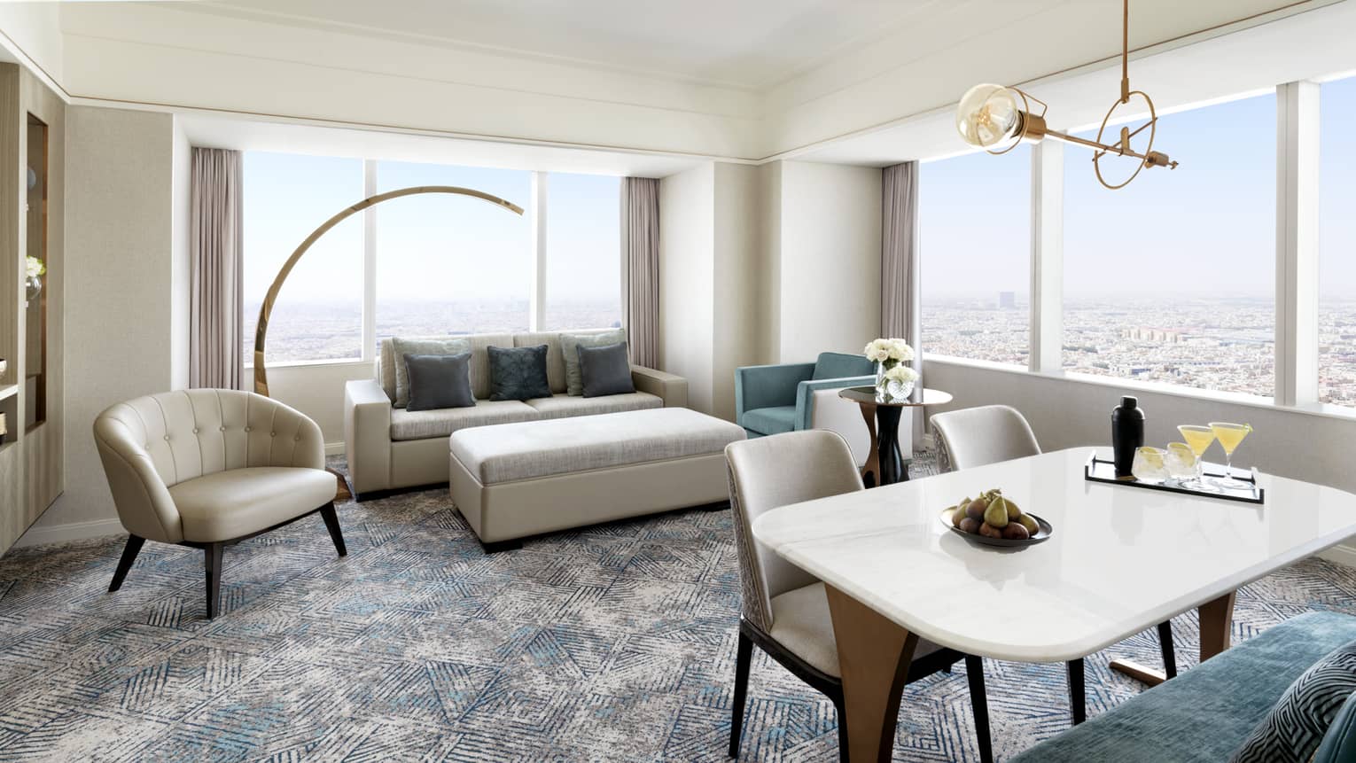 Living area with sofa and two chairs, plus dining table for four