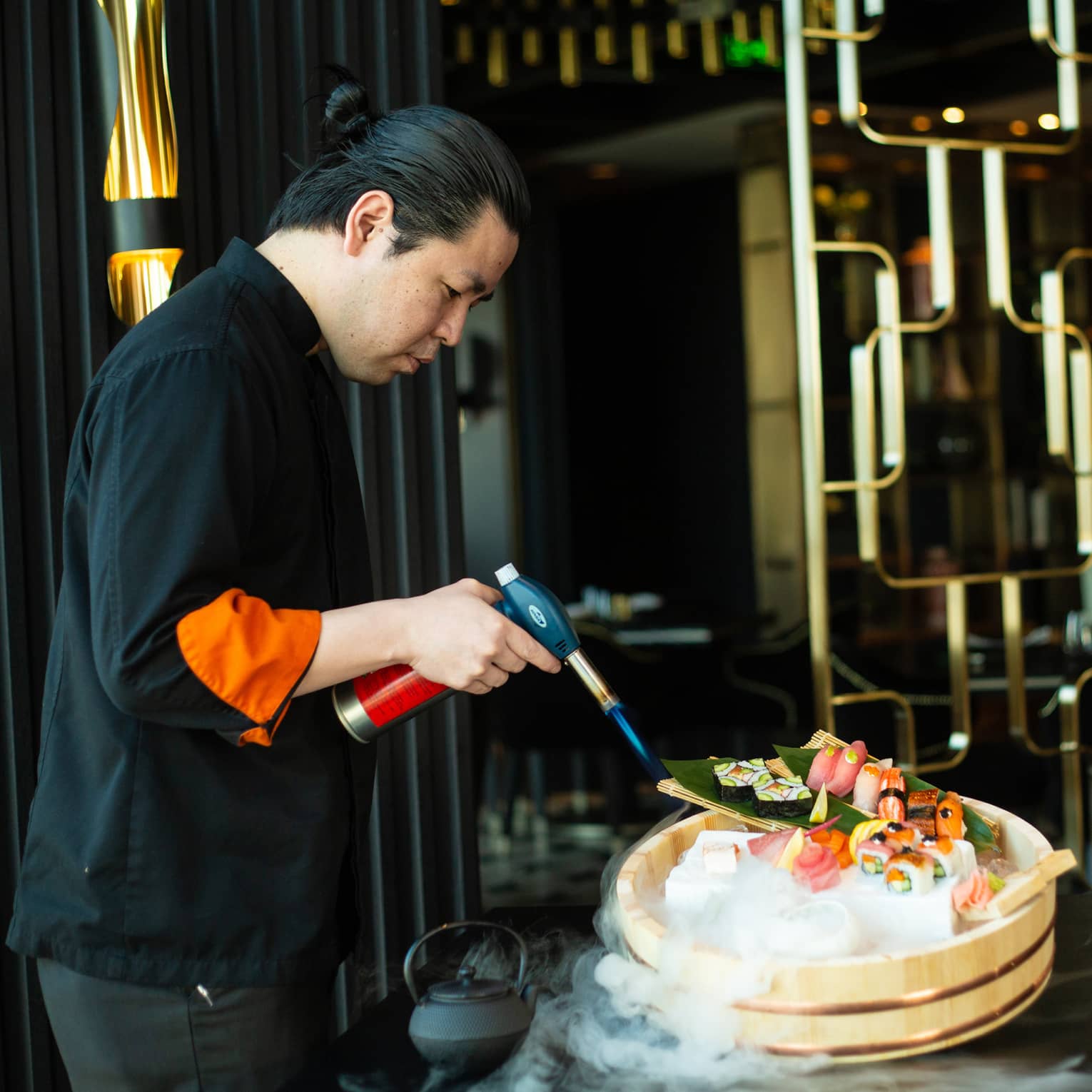 Chef Yonaha uses a torch to put the finishing touches on a signature dish
