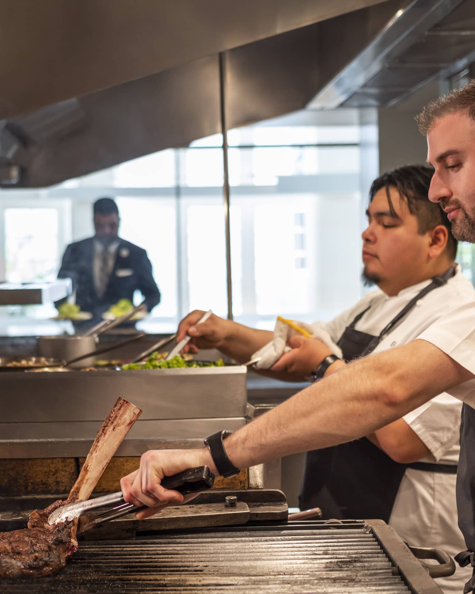 Chefs cooking food in a kitchen.