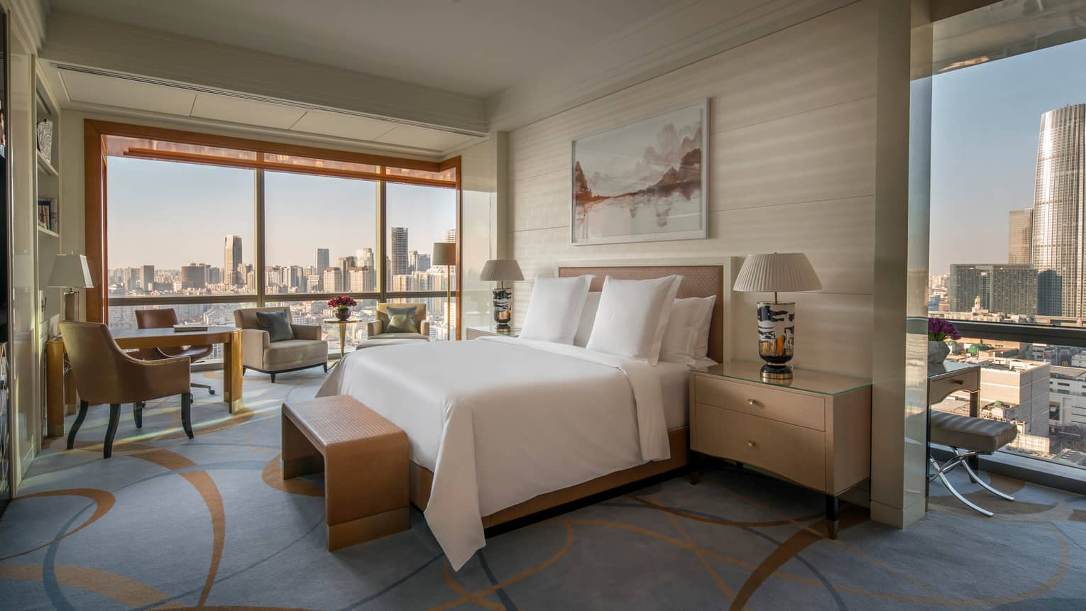 Premier Room bed, bench, desk by large floor-to-ceiling window, city views