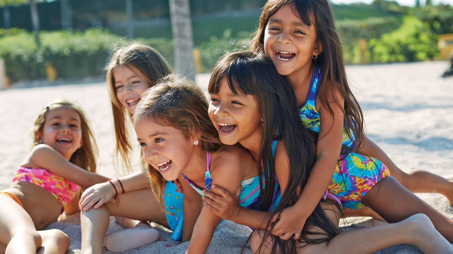 A group of kids playing at a beach.