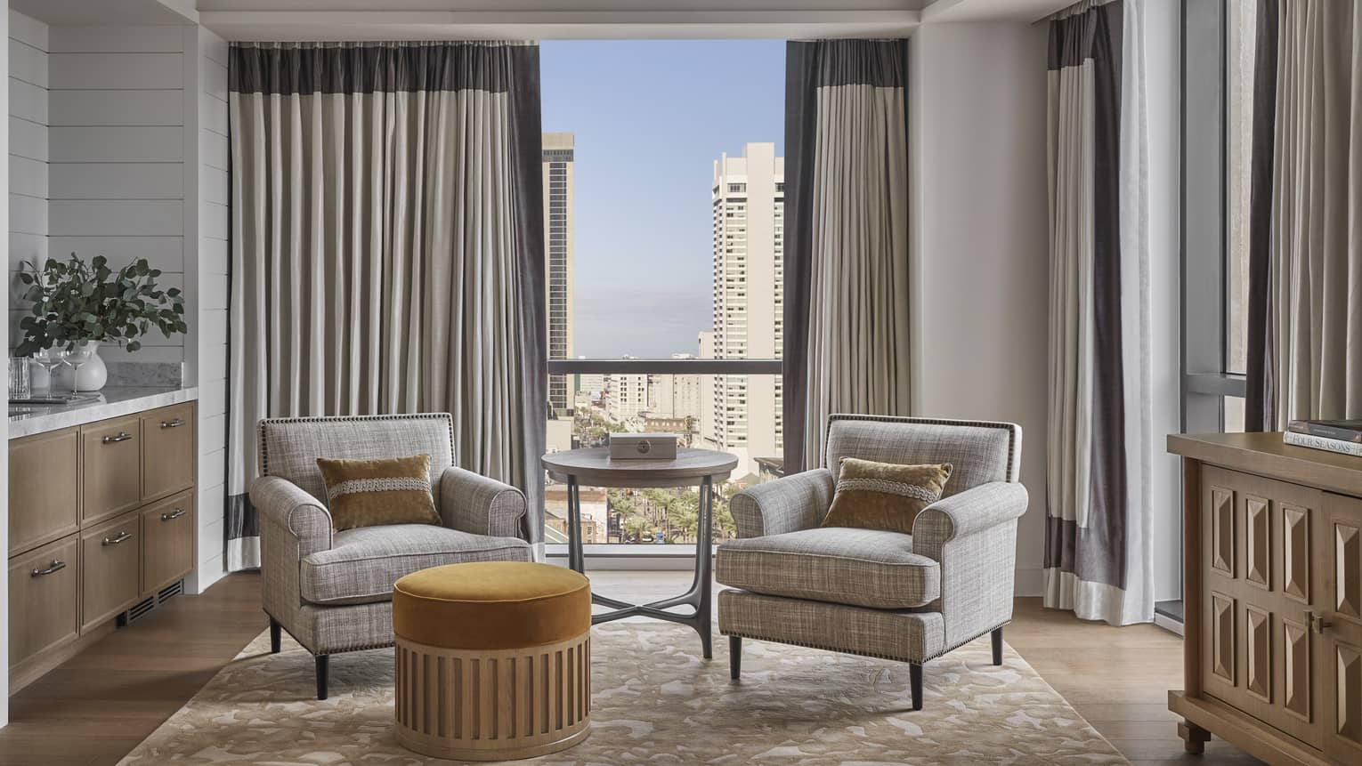 Sitting area with two arm chairs and city view