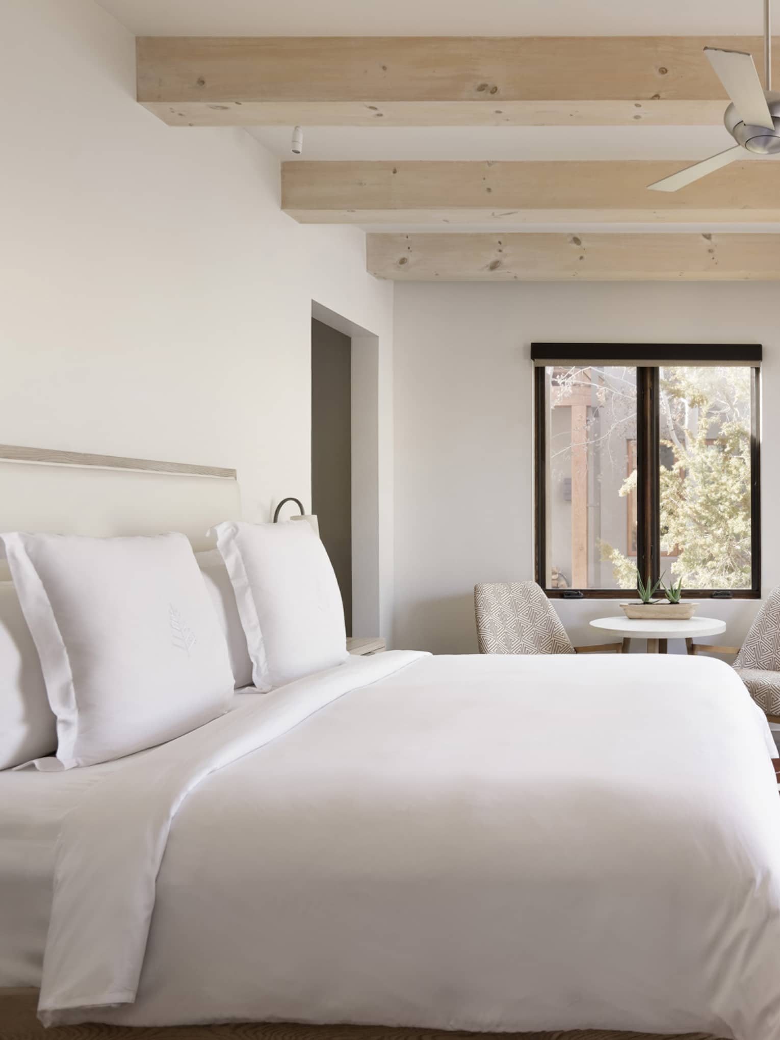 Guest room with king bed and walk-out terrace at Four Seasons Resort Santa Fe