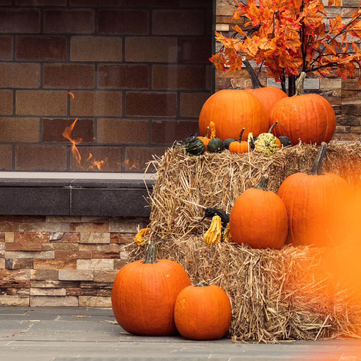 Pumpkins stacked on top of hay bales