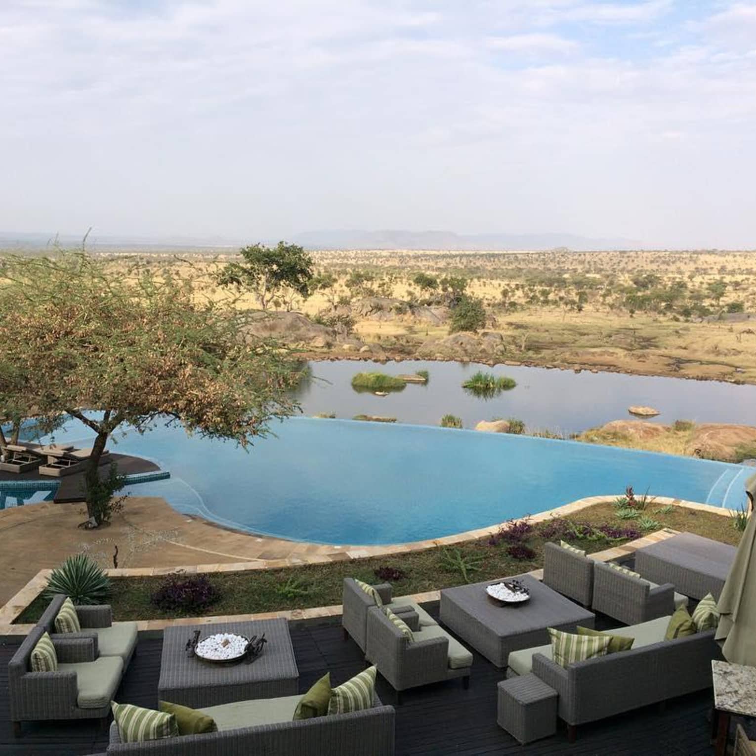View over dining patio, outdoor pool to pond, field