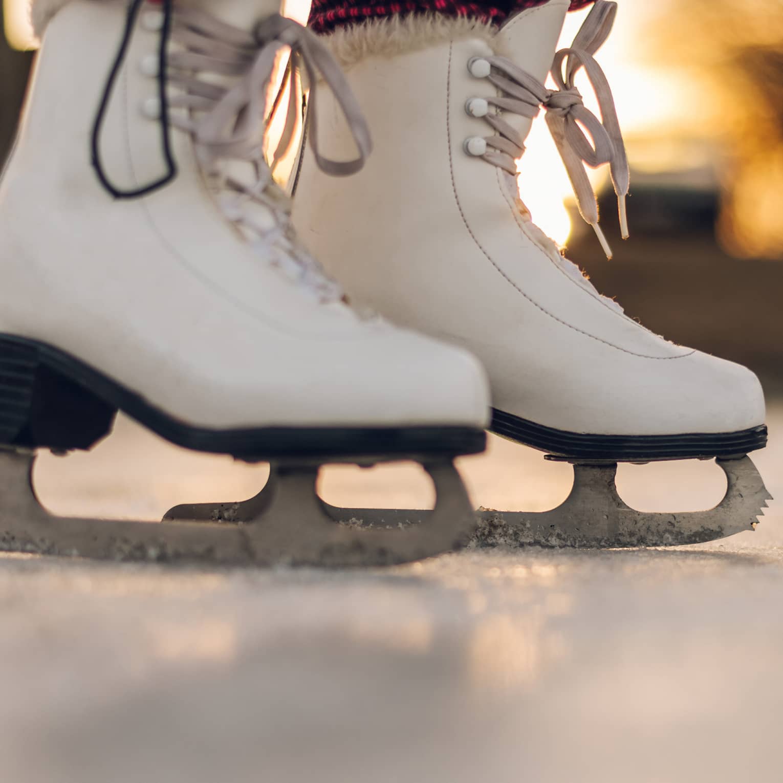A pair of white ice skating boots.