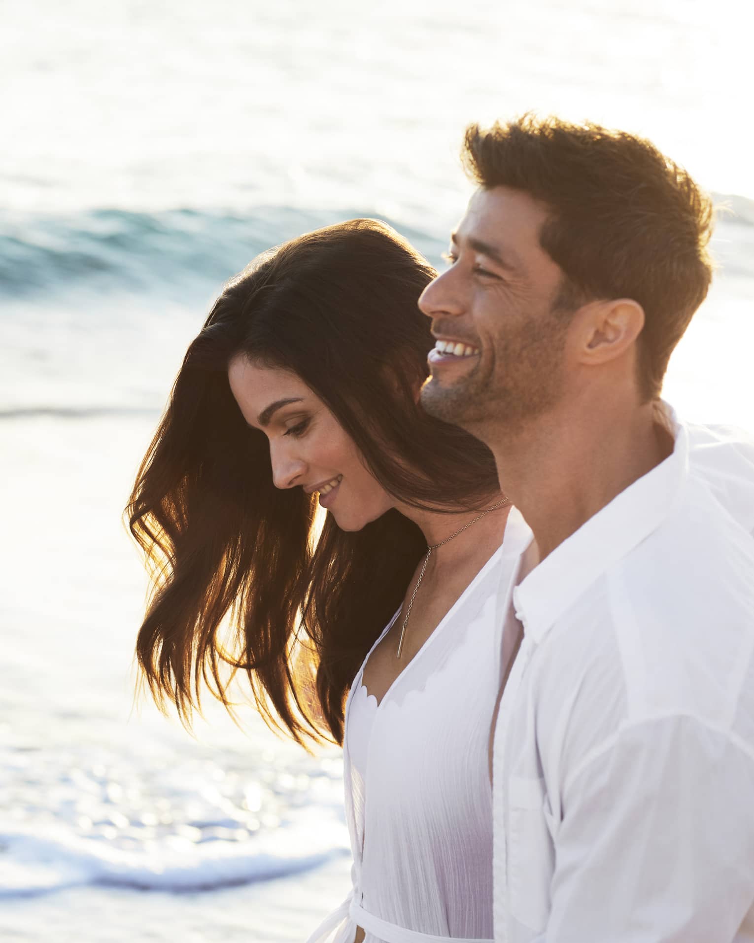 Man and woman walk on the beach