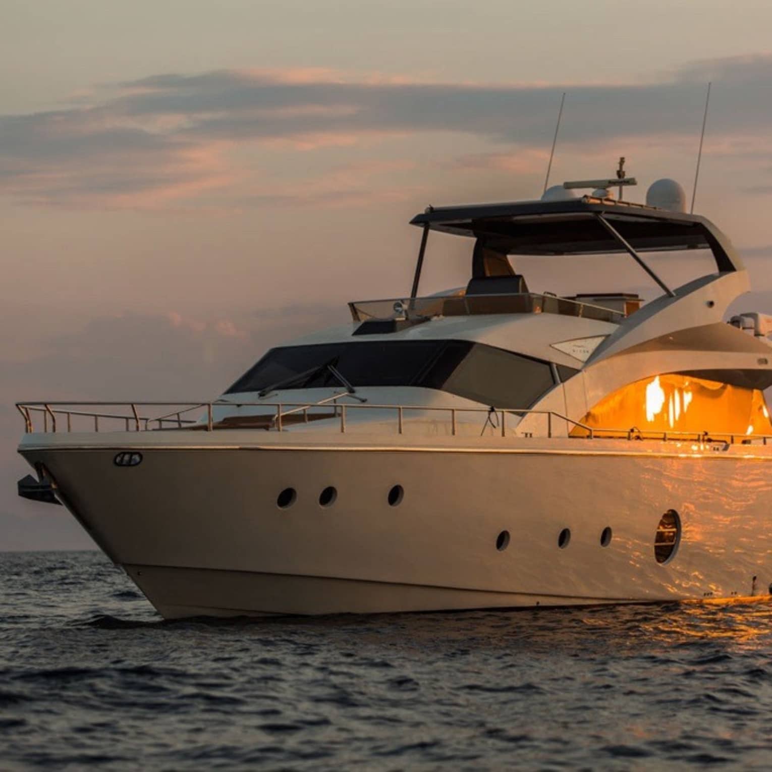 Private charter boat floats on the water at sunset