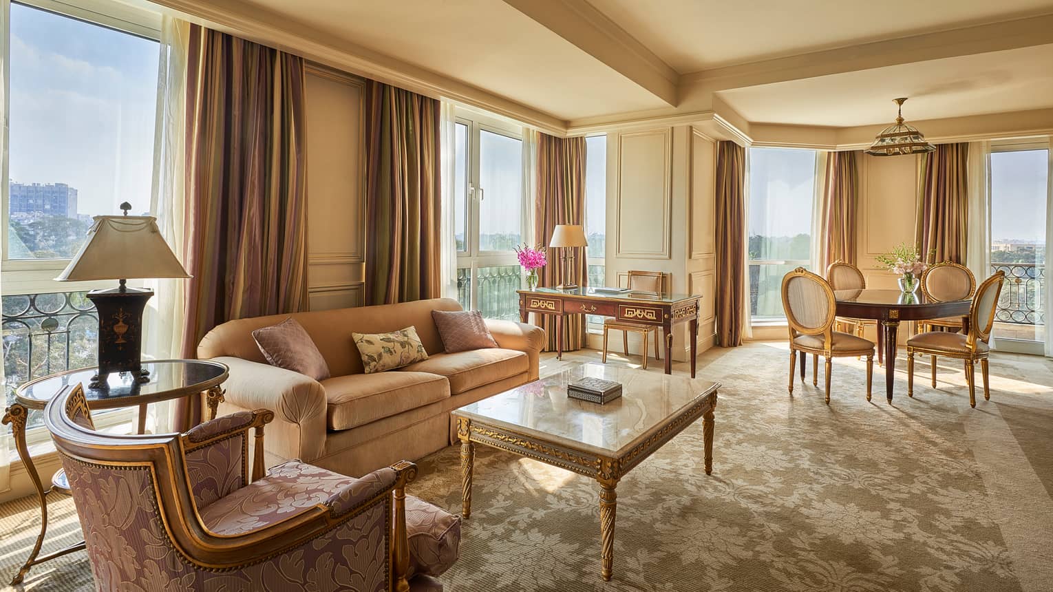 Diplomatic Suite corner living room with pink and cream-coloured sofas, carpets, rug and curtains