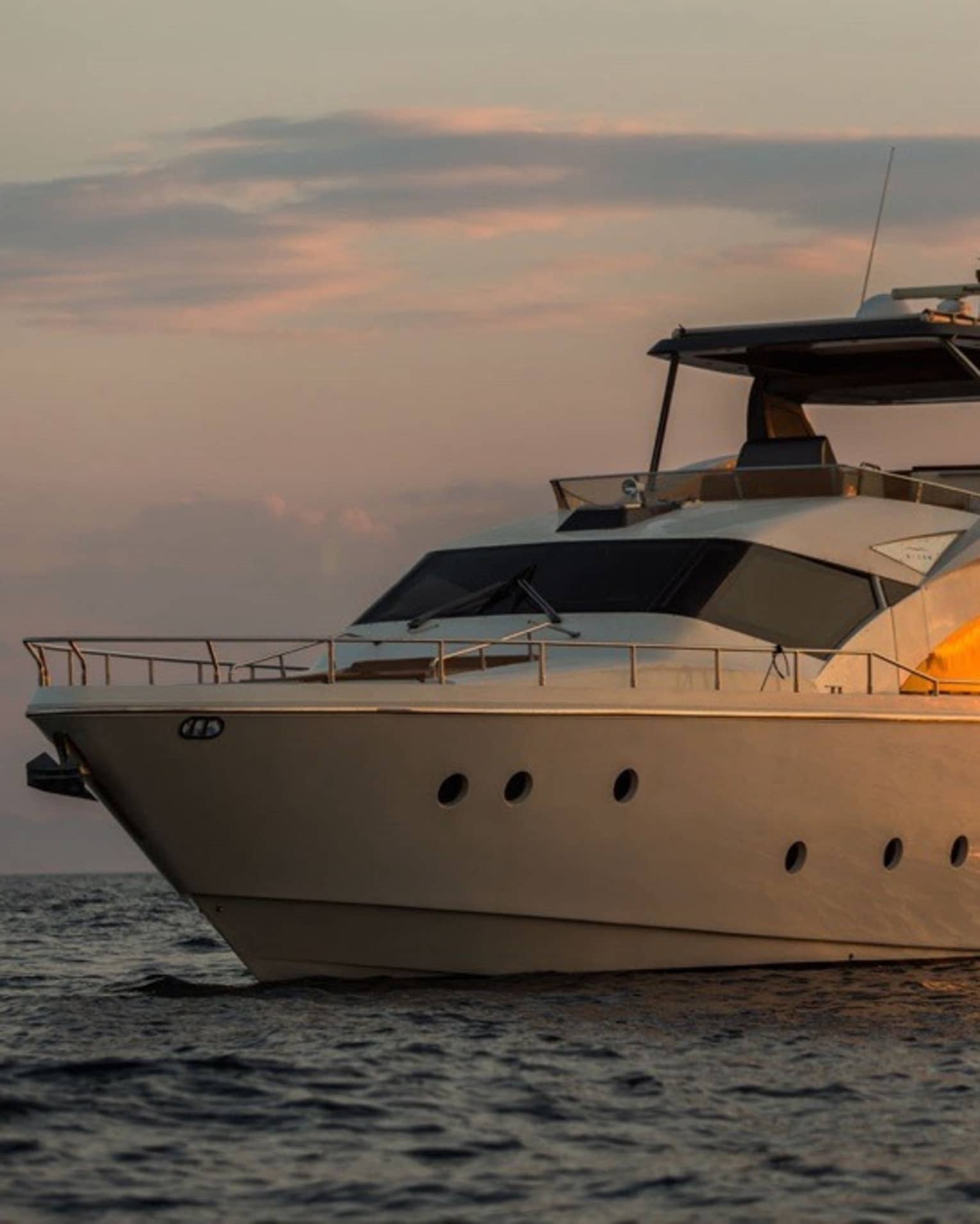 Private charter boat floats on the water at sunset