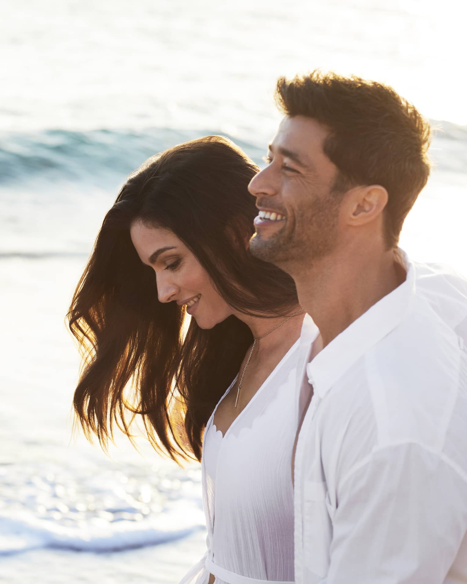 Man and woman walk on the beach
