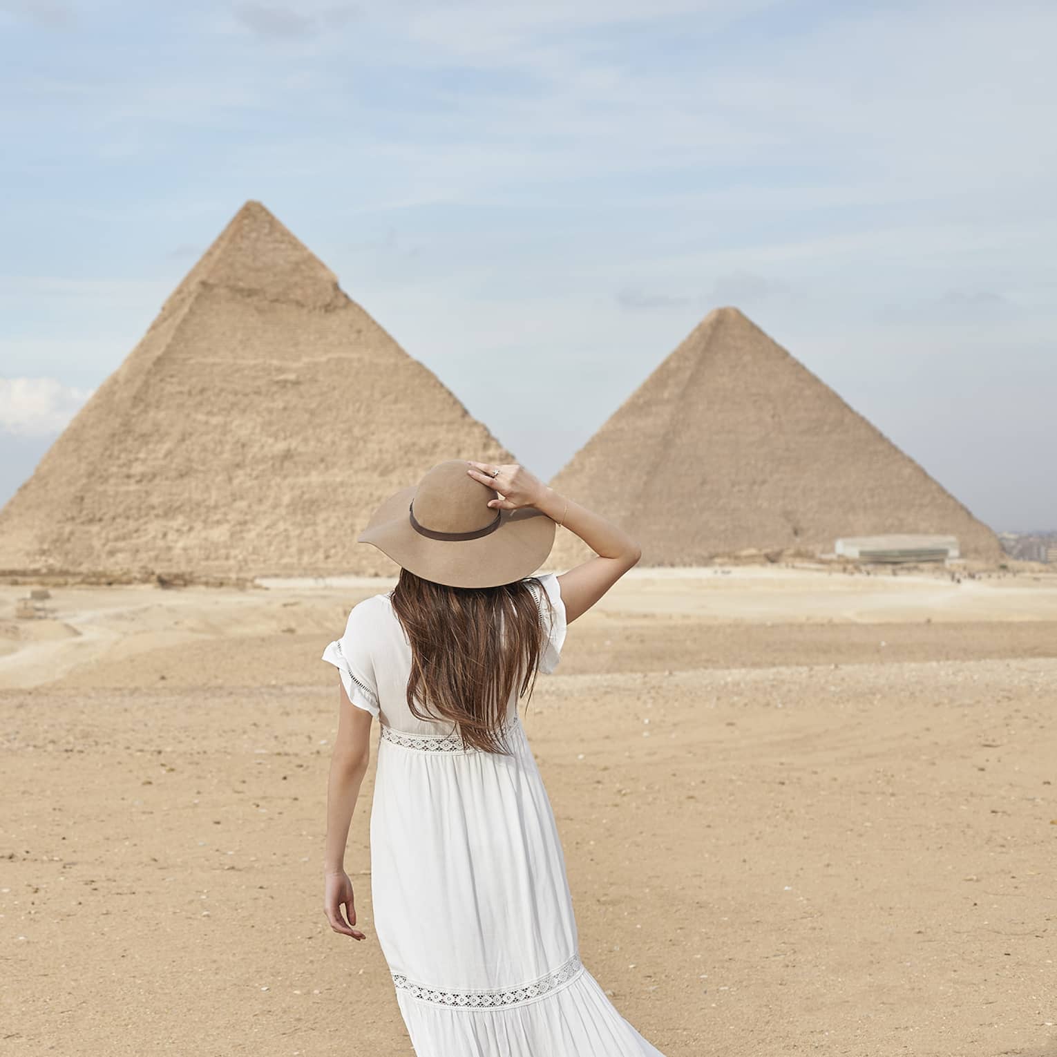A guest wearing a linen dress observing the Great Pyramids