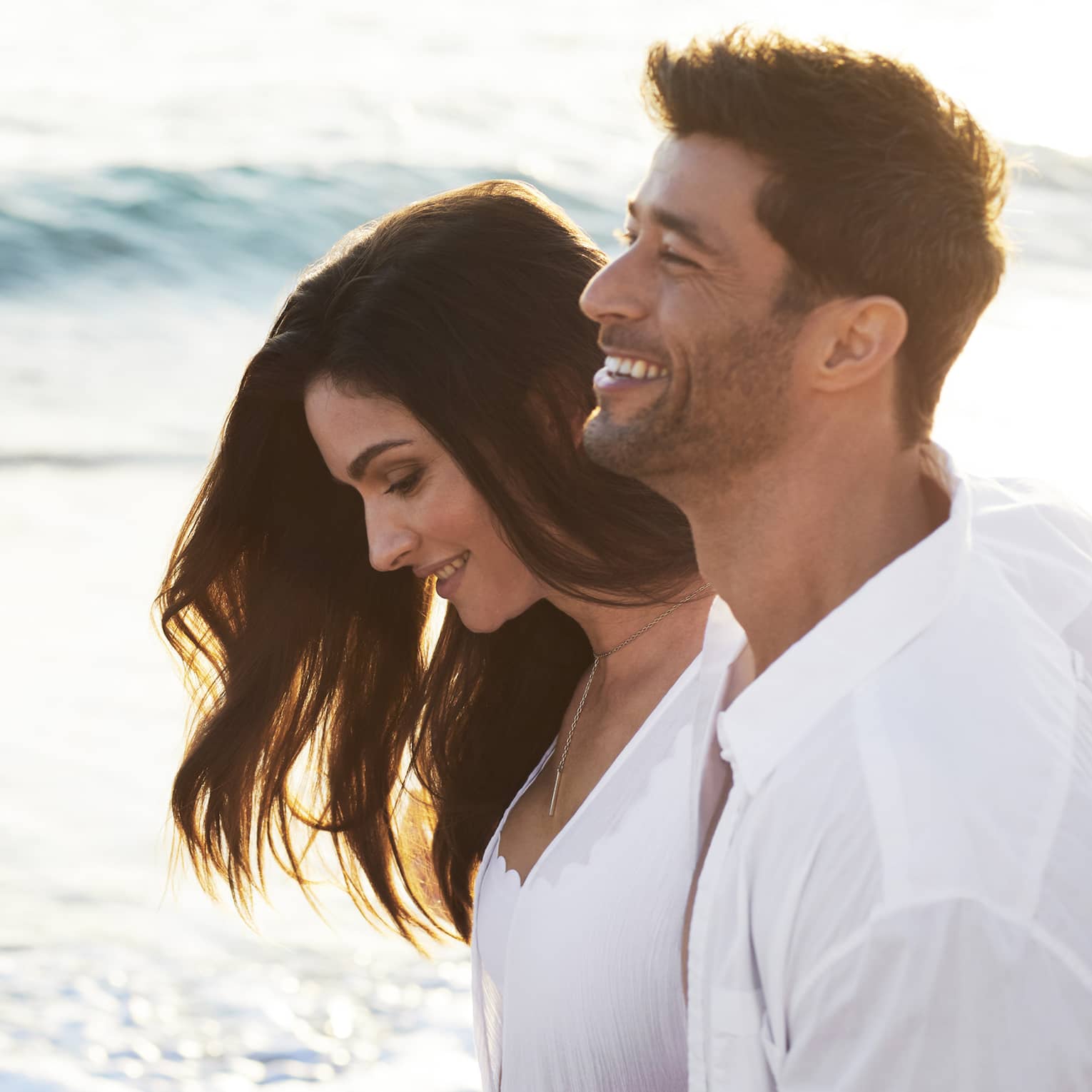 Man and woman walk on the beach