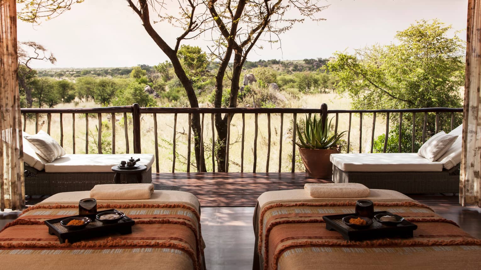 Spa couples massage beds with trays side-by-side in front of patio