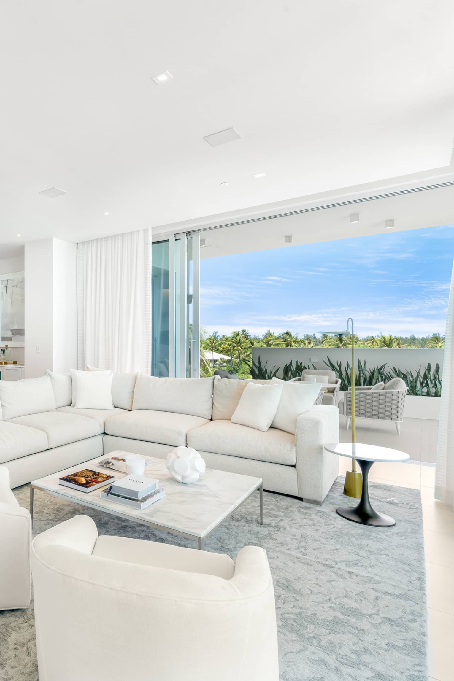 Residence interior living room and kitchen with floor-to-ceiling windows