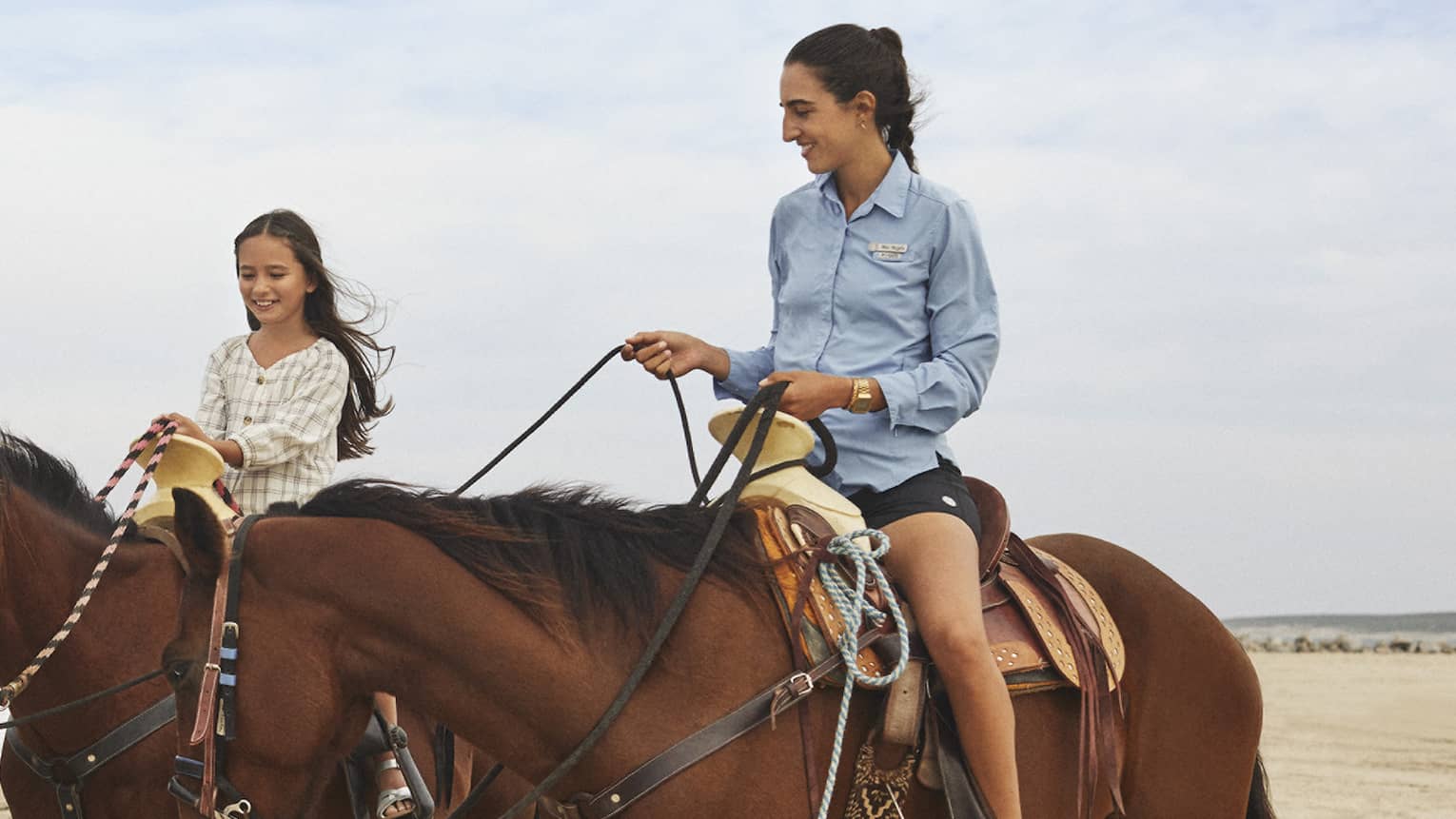 Three women riding on horses.
