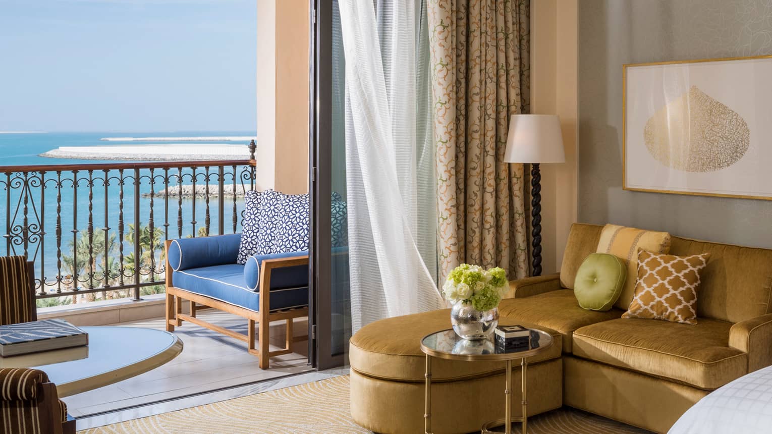Premier Sea-View Room with L-shaped gold sofa beside oversized sliding glass door to balcony