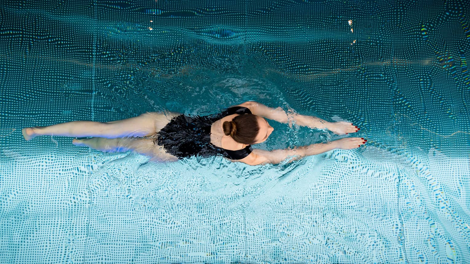 A woman swimming in a pool.
