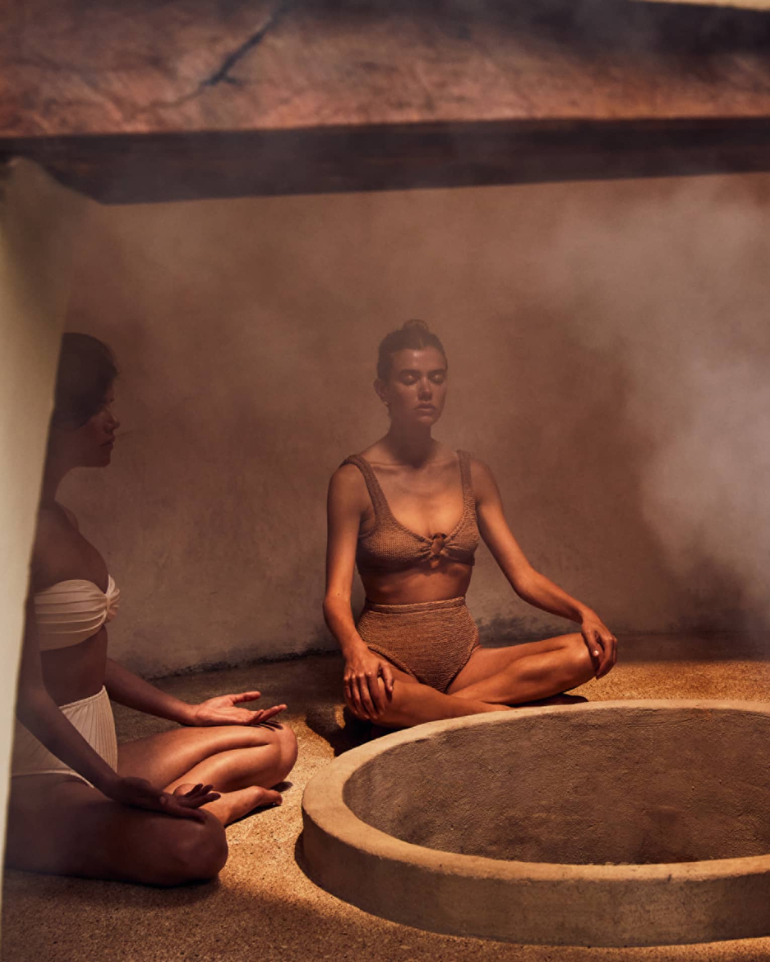 Three people sitting in a heated room with steam.